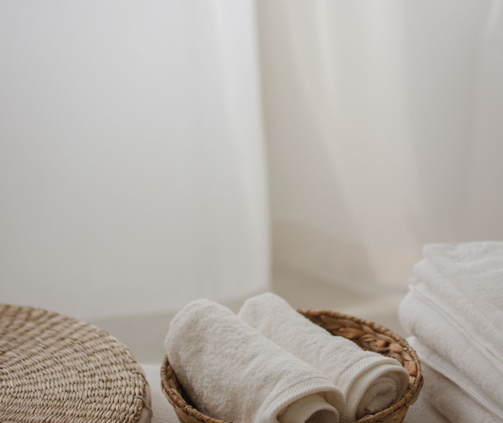 Rolled towels in a woven basket